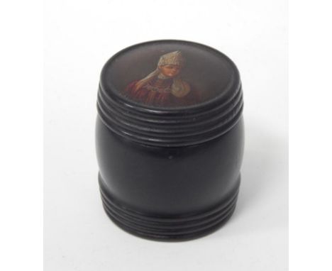 A late 19thC turned ebony barrel shaped box and cover, the cover painted with head and shoulders portrait of a papal figure, 