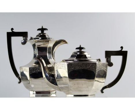 A George V silver tea service, comprising teapot, hot water jug, sugar bowl and milk jug, of octagonal form with engraved scr