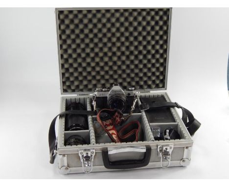 A Canon AE1 SLR camera, with assorted lens in photography case, with tripod, portable carry case