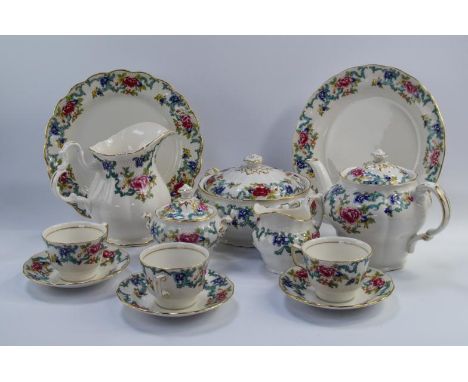 A Royal Doulton and Booths Floradora dinner and tea service, comprising serving plates, dinner plates, tureens, sauce boats, 