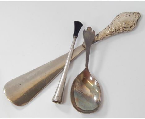 A silver cigarette holder, Birmingham 1954, a silver caddy spoon and silver handled shoe horn, (3)