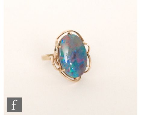 A 9ct single stone opal doublet ring, claw set stone to a plain shank, length of stone 22mm, ring size O. 