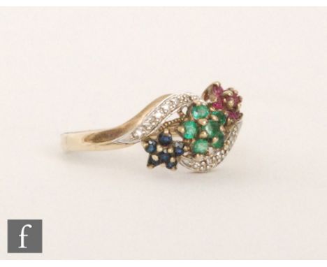 A 9ct hallmarked multi stone ring, to include emerald, ruby and sapphire seven stone clusters within diamond set part borders