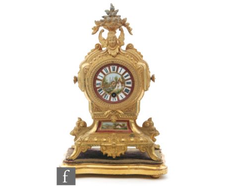 A 19th Century French gilt metal mantle clock, the porcelain dial painted with a cottage near a lake, above a scroll base and