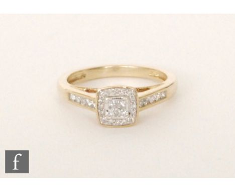 A 9ct hallmarked diamond cluster ring, four square cut stones with a brilliant cut border and diamond set shoulders, ring siz