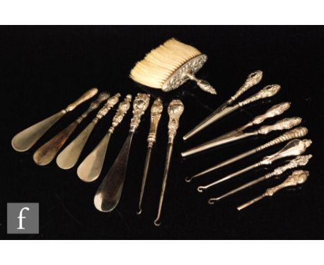 A parcel lot containing five shoe horns with hallmarked silver handles, a hallmarked silver glove stretcher with a similar EP