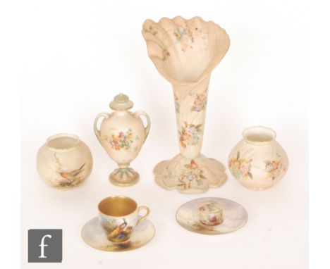 A Royal Worcester cabinet cup and saucer decorated by W. Austin with a hand painted peacock perched on a pine cone branch tog