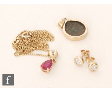 A pair of 9ct hallmarked collar set diamond stud earrings, with a 9ct ruby and diamond set pendant suspended from a fine 9ct 