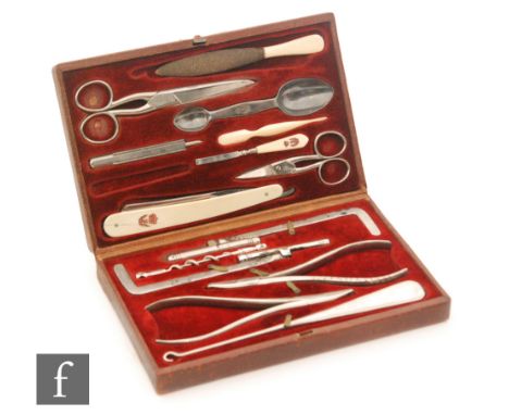 A 19th Century portable mahogany cased gentleman's dressing set with double fitted interior with cut throat razor, scissors a