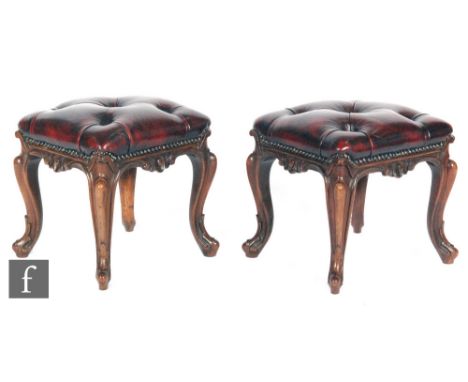 A pair of Victorian rosewood foot stools of square form, with acanthus carved cabriole legs, later upholstered in ox blood bu