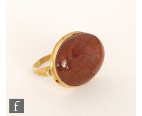 A 19th Century oval carnelian intaglio cut with a phoenix to an 18ct mount, converted to a ring with chased decoration, total