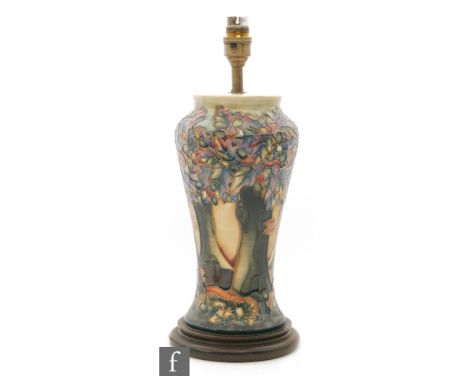 A Moorcroft Pottery table lamp decorated in the Knightwood pattern designed by Rachel Bishop, affixed to a wooden plinth (mar