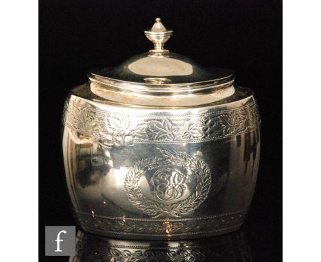 A Victorian hallmarked silver tea caddy of oval form, engraved with bands of floral decoration and monogram to front, the hin