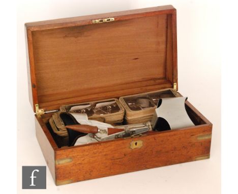 Two Edwardian stereoscopic viewers, together with a large quantity of cards by Underwood and Underwood and other makers depic