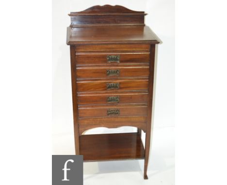 An Edwardian mahogany music cabinet, fitted with five fall-front drawers above a stretcher shelf, height 107cm and width 51cm