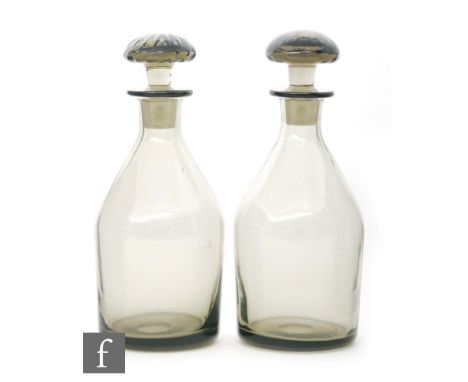 A pair of Whitefriars decanters, shape M74 by Barnaby Powell, both in pewter, height 14.5cm. (2)