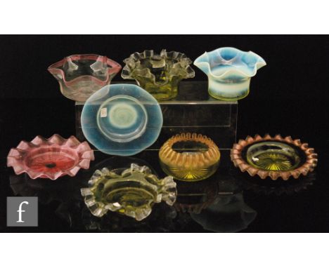 An early 20th Century finger bowl of circular section with frill rim and a graduated straw opalescence with the matched shall