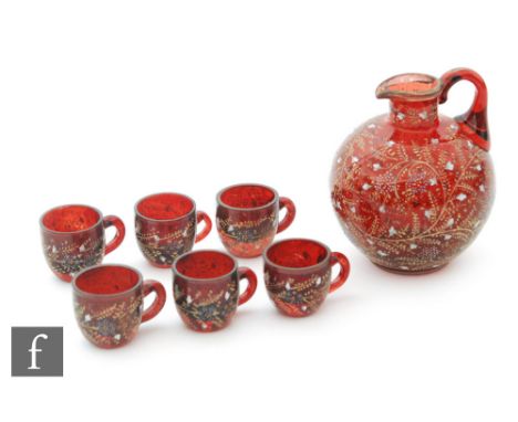 A Continental liqueur set comprising a ruby jug with enamelled floral decoration, height 11cm, with six matching handled glas