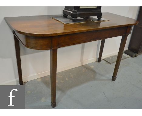 A late Georgian mahogany console table or table end section of rounded rectangular form, with a plain apron above square tape