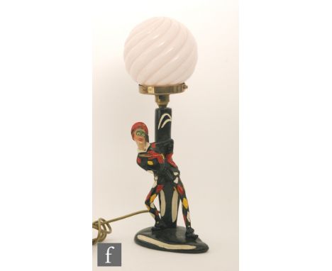 A 20th Century table lamp with pink shade modelled as masked crown wearing a red hat, height 48cm