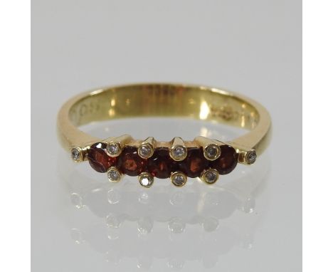 An 18 carat gold ruby and diamond half hoop eternity ring, boxed