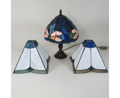 A Tiffany style table lamp, 40cm high, together with three leaded lamp shades