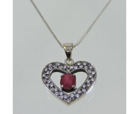 A 9 carat gold and ruby heart shaped pendant, on chain