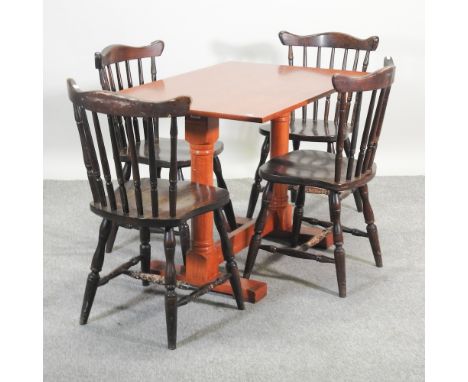 A light wood dining table, 107 x 68cm, together with a set of four spindle back dining chairs