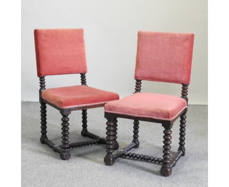 A set of six red upholstered dining chairs on bobbin turned legs