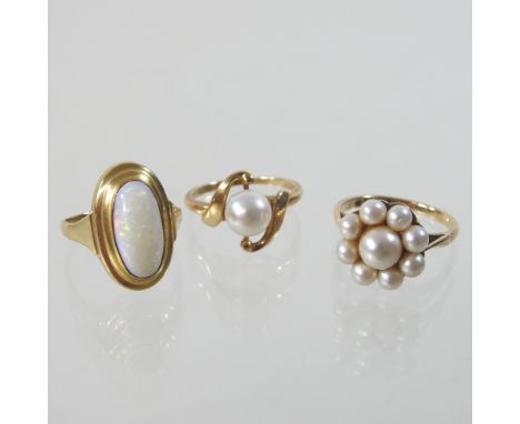 A 9 carat gold opal single stone ring, size K, together with a 15 carat gold pearl ring, size K and a 9 carat gold pearl ring