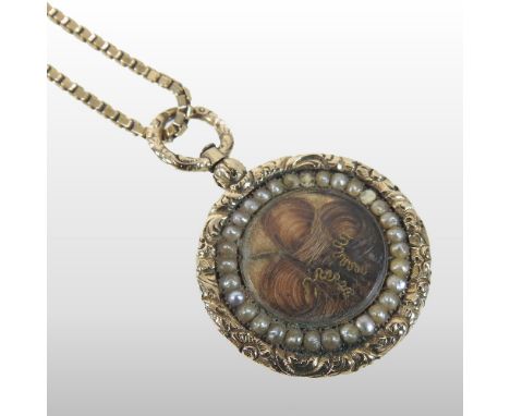 A 19th century unmarked memorial necklace, suspended with a woven hair pendant, with a pearl surround and ornate gilt mount, 