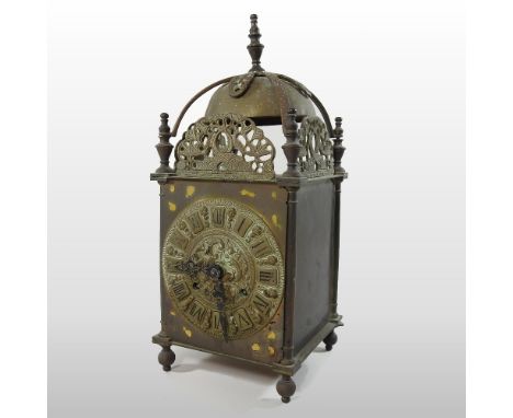 A brass cased lantern clock, the case surmounted by a bell, the movement striking on a bell, 36cm high