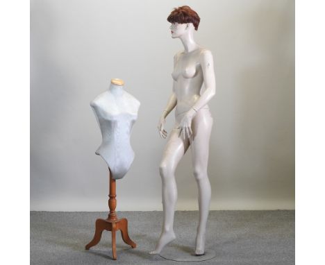 A life size shop mannequin, together with a smaller dressmaker's dummy, on wooden base