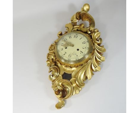 A gilt painted Cartel style wall clock, 54cm high