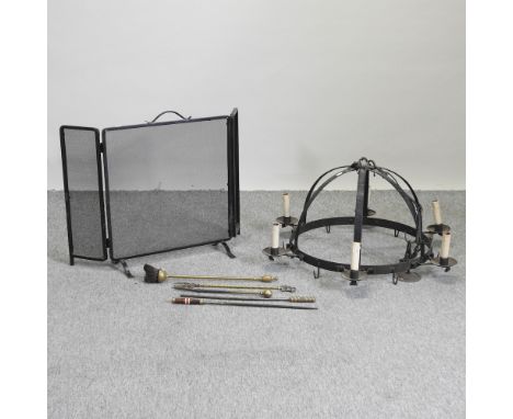 A black painted iron circular ceiling light, 77cm diameter, together with a collection of fire tools and a screen