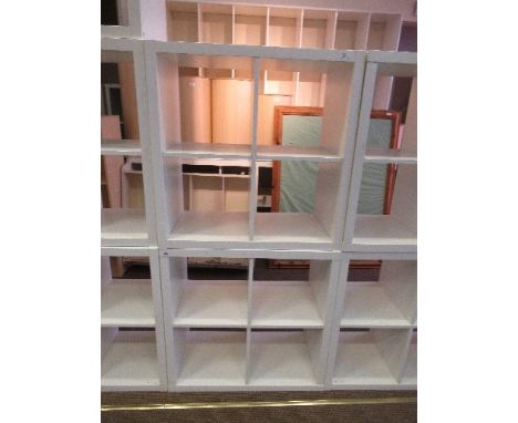 Four 3 x 4 cube white modern square shelf units