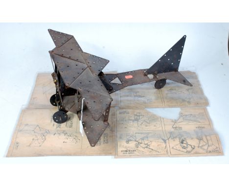 Unusual German Constructed model of a Bi-Plane, made from black painted components, similar to Meccano, sold with 4 paper she