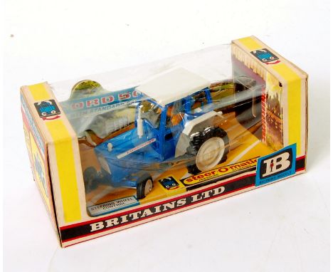 Britains No.9527 Ford 5000 Tractor with standard safety cab, blue and white body with white hubs, and driver, in the original