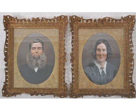 A pair of mid-late nineteenth century unsigned American oil paintings, each portrait depicting a woman and a man, the lady dr