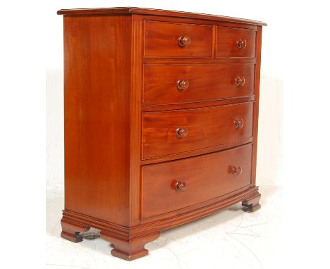 A Victorian antique style chest of drawers having a flared top with a&nbsp; two over three drawer configuration with turned k