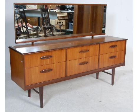 A vintage retro 1970's teak wood dressing table having a bank of six drawers with lipped recessed handles to each, mounted wi