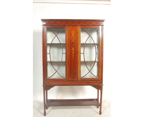 A nearly 20th Century Edwardian mahogany china display cabinet having&nbsp; frieze top with satin wood inlaid garland decorat