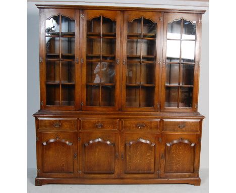 A large and impressive antique style 20th Century farmhouse royal oak library bookcase / dresser / sideboard having four glaz