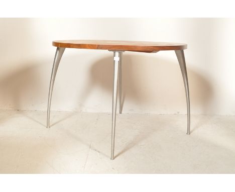 A retro vintage industrial late 20th century dining table having a circular table top raised on tapering curved legs. Measure