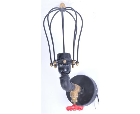 A good contemporary steampunk industrial converted wall light lamp in the form of an exterior gas / water tap having red twis