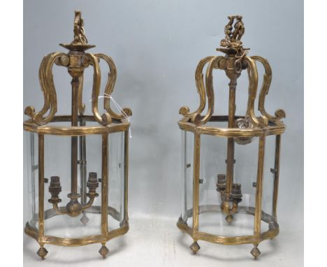 A pair of 19th Century Victorian brass and glass hall / porch lanterns having curved glass panels suspended from a scrolled f