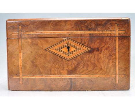 A 19th century walnut tea caddy having tea caddy with inlaid decoration to the lid and escutcheon and having fully appointed 