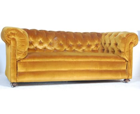 A Victorian 19th century Chesterfield sofa settee with bun feet and castors having yellow velour upholstered frame with butto