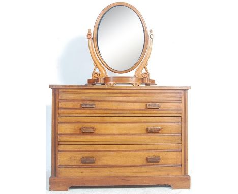 A mid 20th century mahogany chest of drawers having a bank of three spacious drawers, wooden pulls with reeded fronts raised 