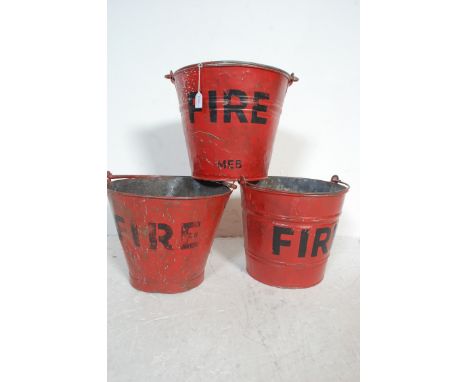 A group of three vintage retro 20th century galvanised buckets / fire men buckets of tapered form with swing handle atop pain